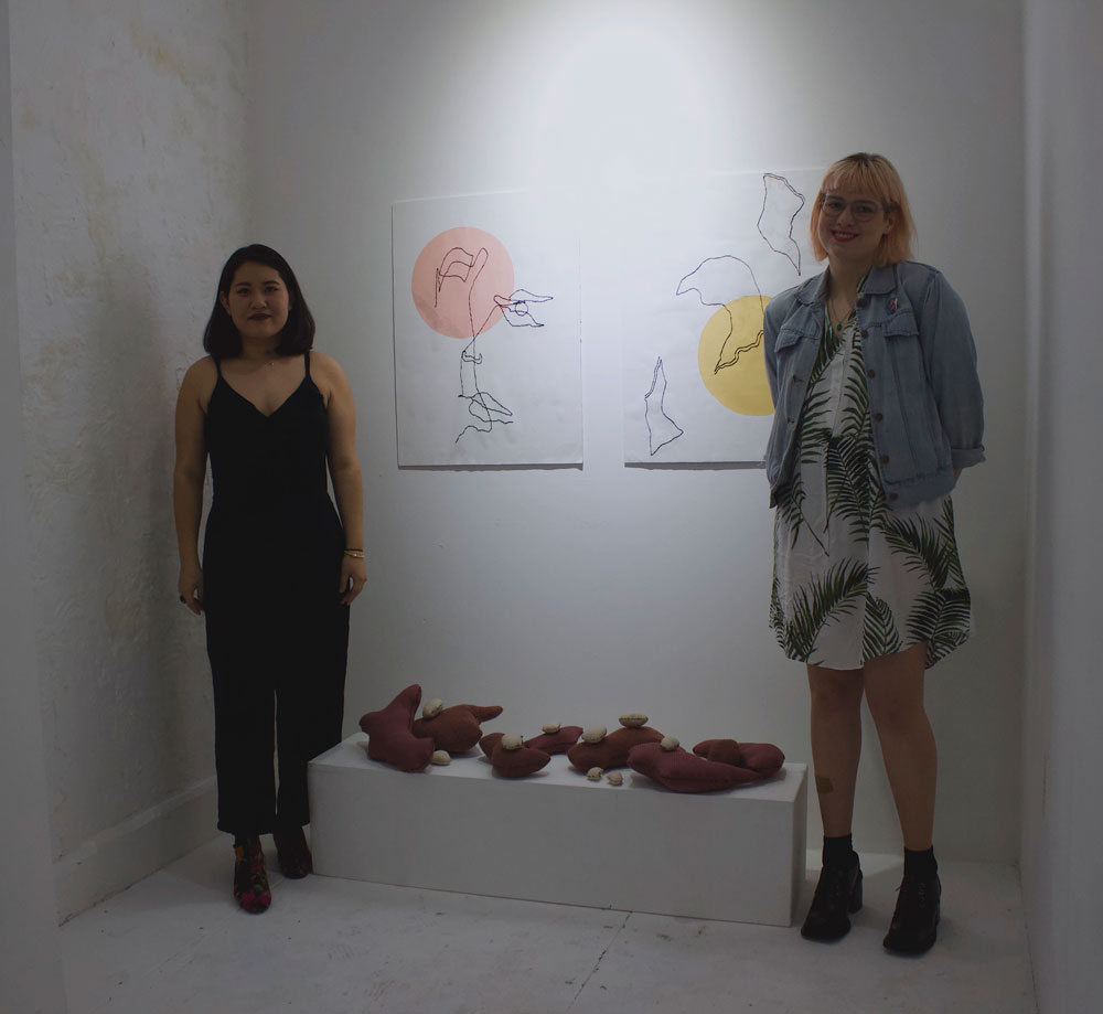 photograph of two artists in the gallery
