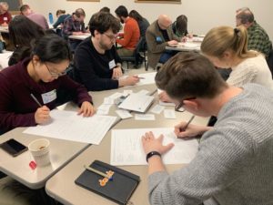 workshop participants filling out round robin worksheet